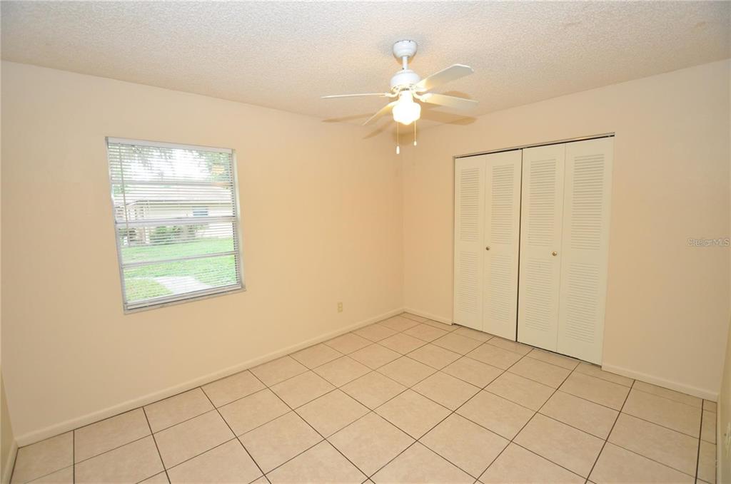 1434 East Fern Road, Unit 1434 Lakeland, FL 33801 - Photo 10 of 13 an empty room with windows and fan