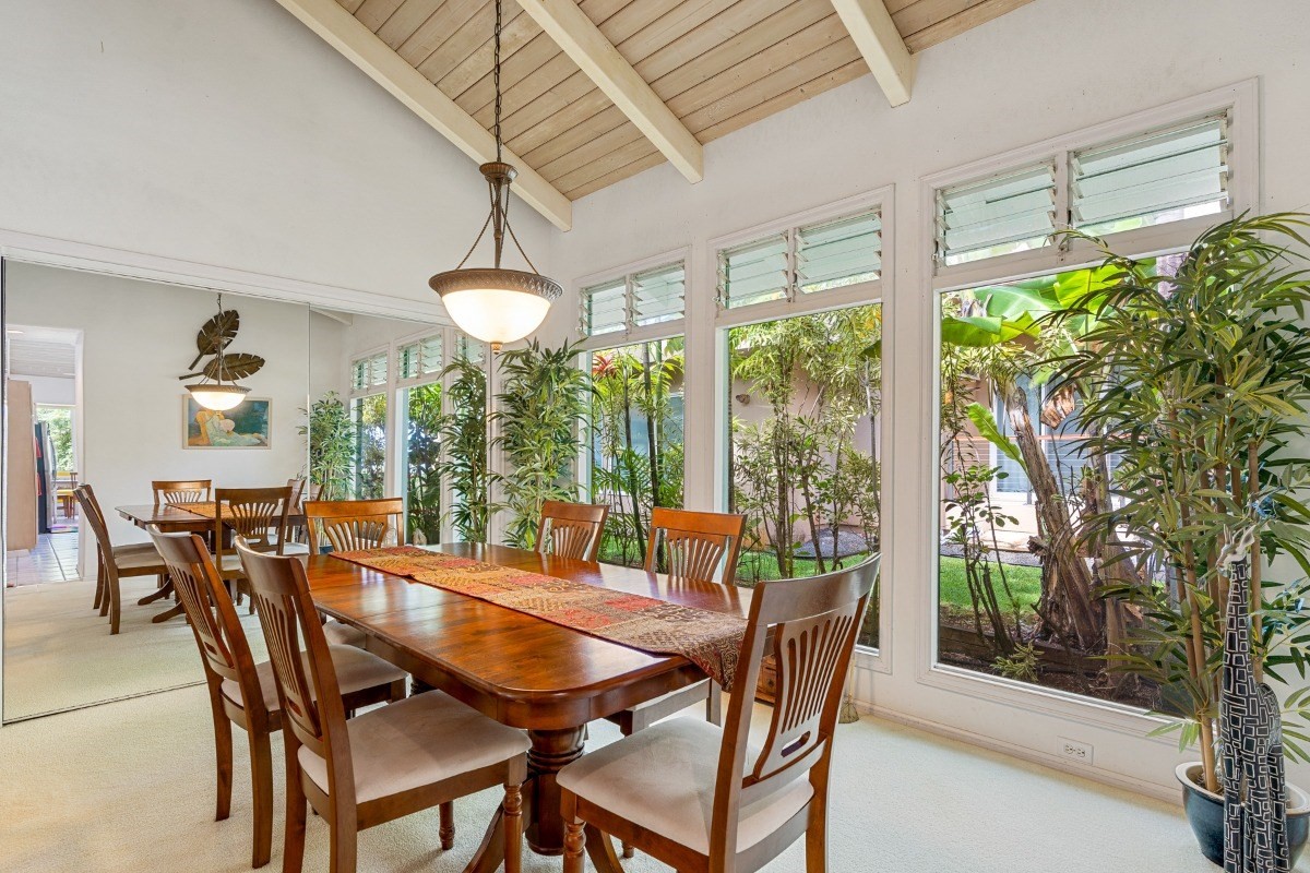 3791 Punahele Road Princeville, HI 96722 - Photo 18 of 30 a dining room with furniture a chandelier and wooden floor