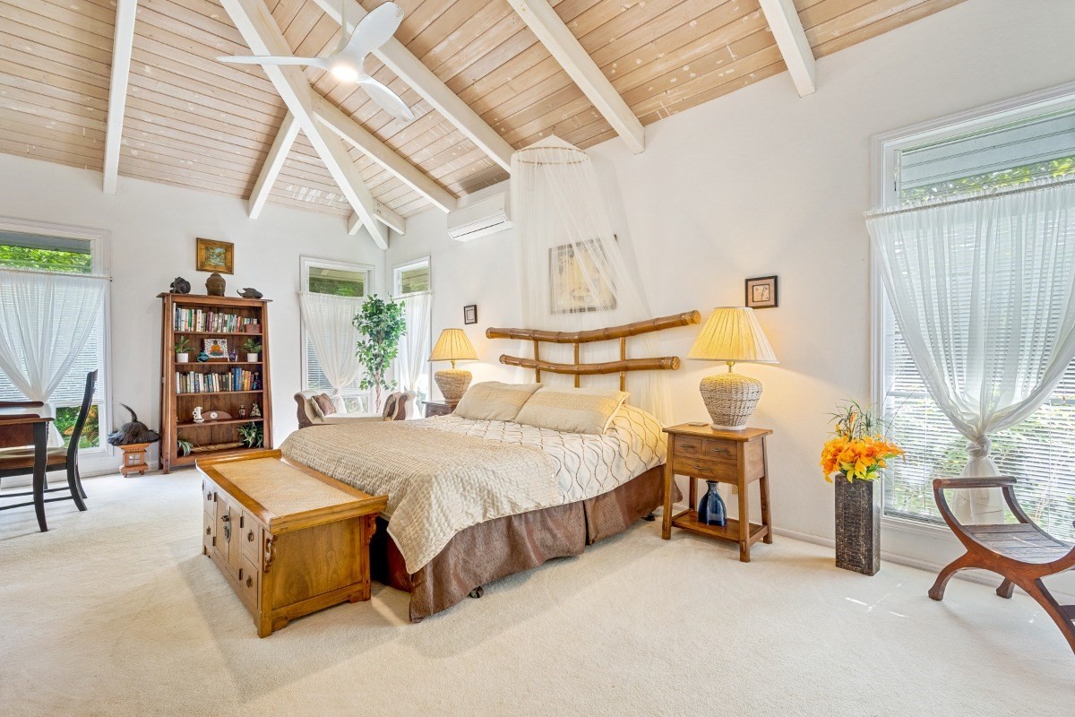 3791 Punahele Road Princeville, HI 96722 - Photo 19 of 30 a bed room with a bed and a chair