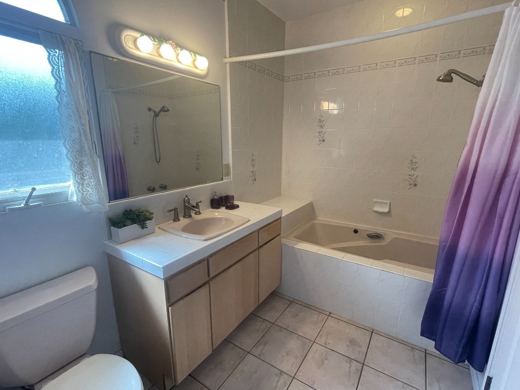 3791 Punahele Road Princeville, HI 96722 - Photo 20 of 30 a bathroom with a tub sink and mirror