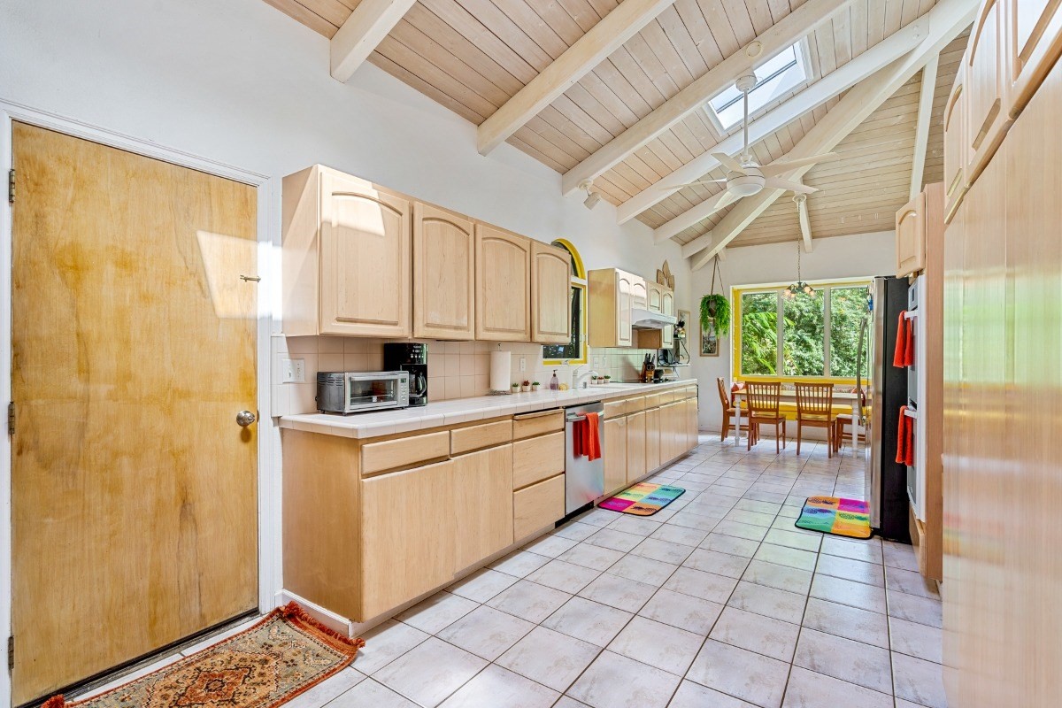 3791 Punahele Road Princeville, HI 96722 - Photo 27 of 30 a kitchen with a sink a stove and cabinets