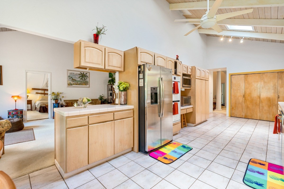 3791 Punahele Road Princeville, HI 96722 - Photo 5 of 30 a kitchen with stainless steel appliances kitchen island granite countertop a refrigerator and a stove top oven