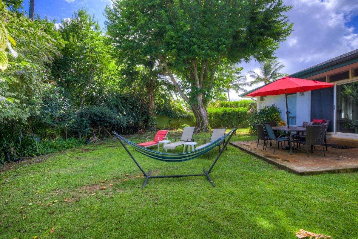 3791 Punahele Road Princeville, HI 96722 - Photo 9 of 30 a view of a backyard with table and chairs under an umbrella