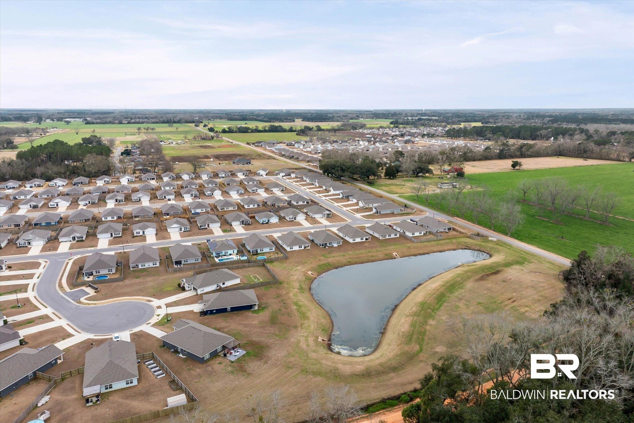 17041 Muse Street Loxley, AL 36551 - Photo 40 of 44 Aerial view of property and surrounding area featuring nearby suburban area and a large body of water