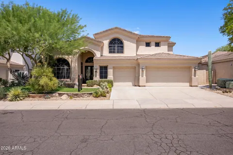 a front view of a house with a yard and a garage