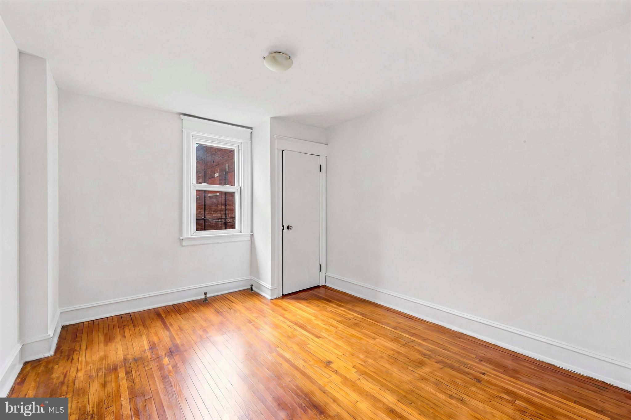 55 Richfield Road Upper Darby, PA 19082 - Photo 26 of 33 an empty room with wooden floor and windows