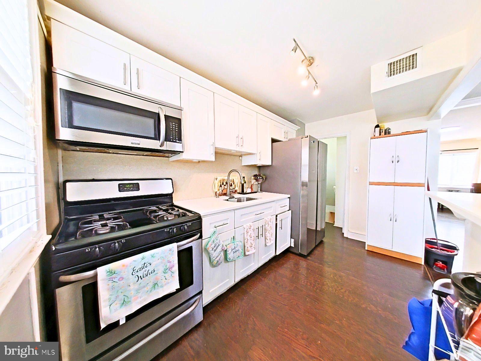 5844 Saul Street Philadelphia, PA 19149 - Photo 18 of 36 a kitchen with a stove and a microwave