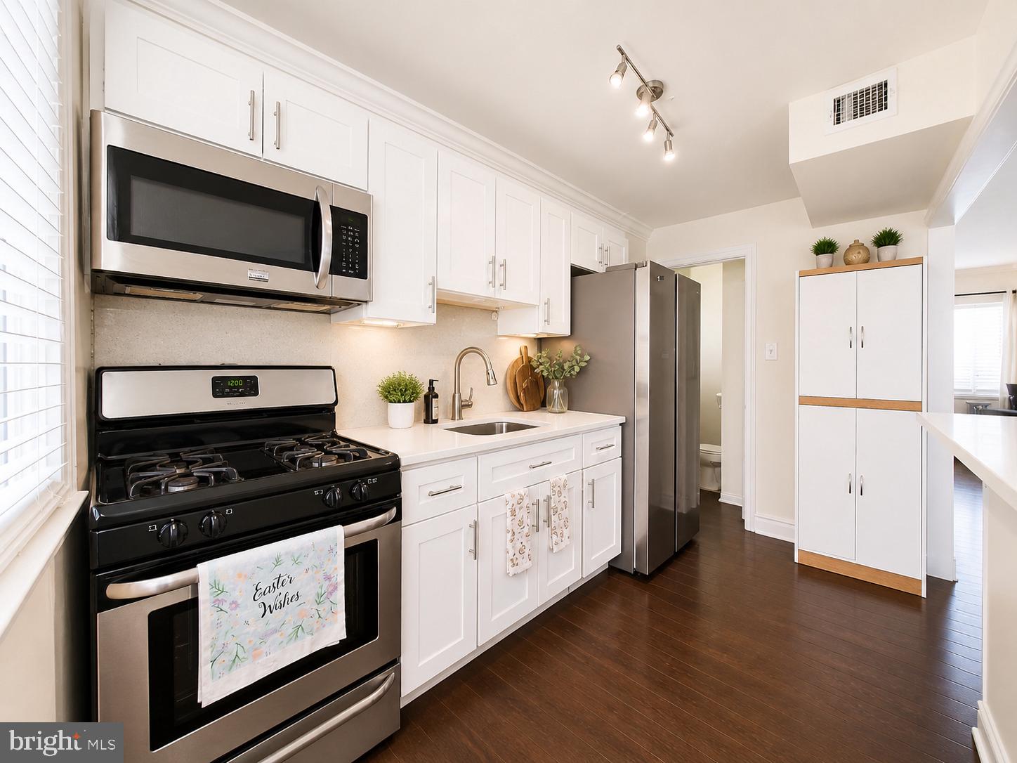 5844 Saul Street Philadelphia, PA 19149 - Photo 5 of 36 a kitchen with stainless steel appliances a stove microwave and refrigerator