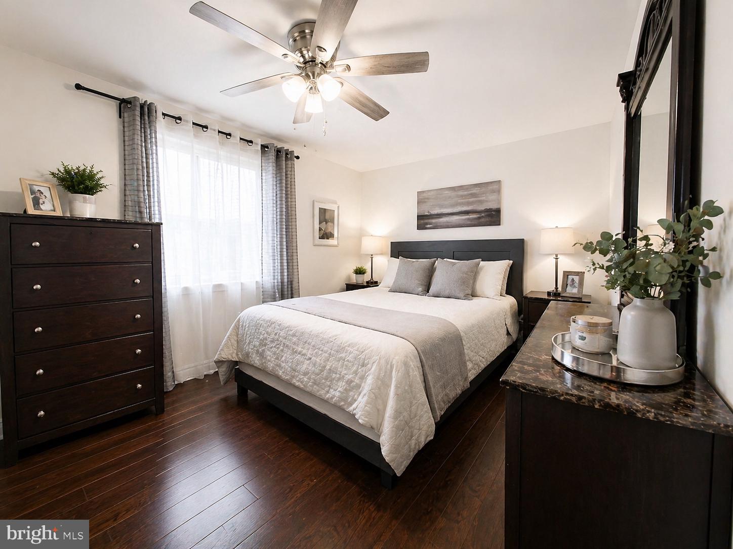 5844 Saul Street Philadelphia, PA 19149 - Photo 6 of 36 a bedroom with a large bed potted plant and a dresser