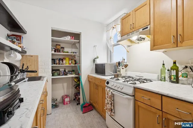 a kitchen with sink refrigerator and cabinets