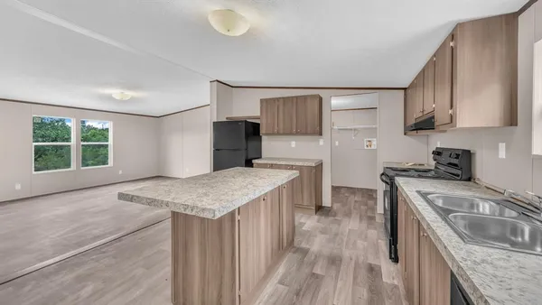 a kitchen that has a sink a stove top oven a counter space and cabinets
