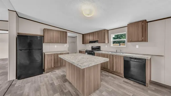 a kitchen with a refrigerator sink and cabinets