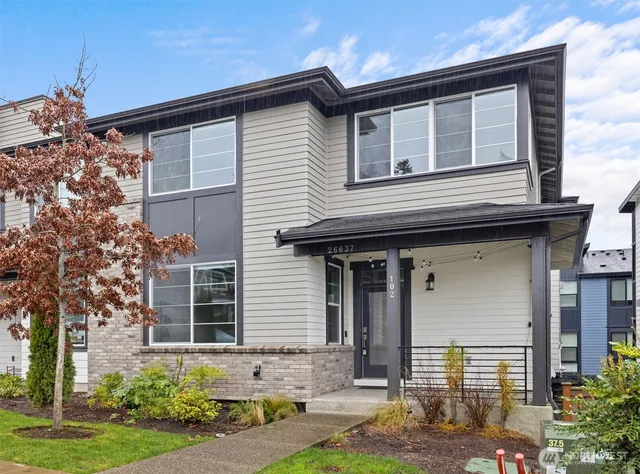 a front view of a house with garden