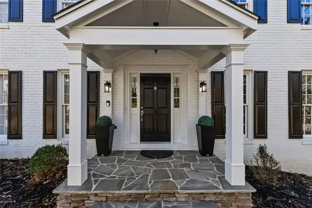 a view of an entryway with wooden floor and staircase