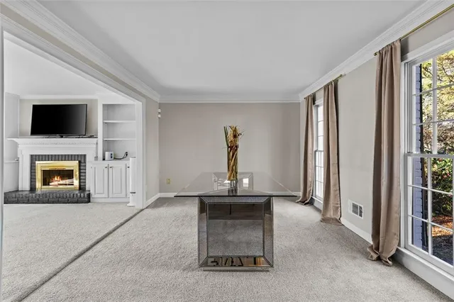 an empty room with fireplace and windows