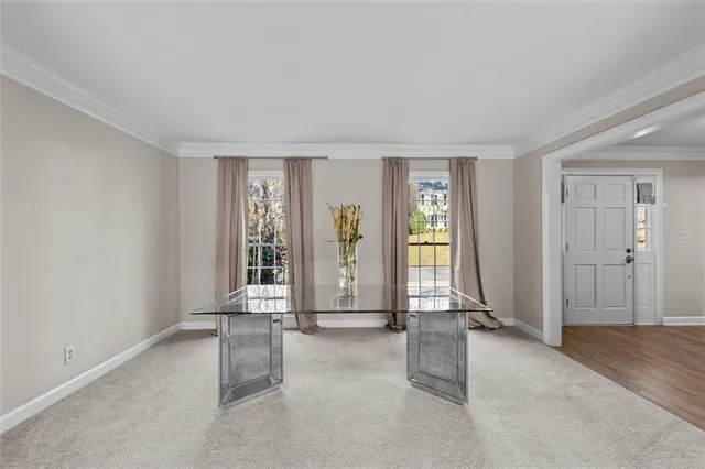 a view of a livingroom with a fireplace a ceiling fan and a couch
