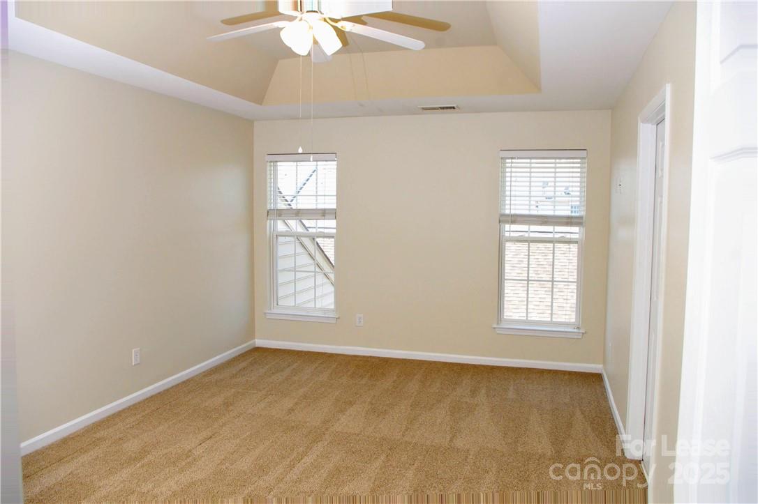 8339 Viewpoint Lane Cornelius, NC 28031 - Photo 16 of 30 an empty room with windows and fan