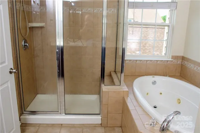 a bathroom with a bathtub and shower