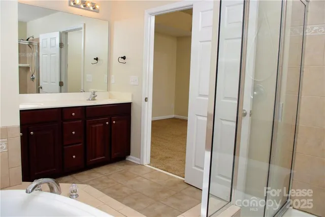a spacious bathroom with a sink and a mirror