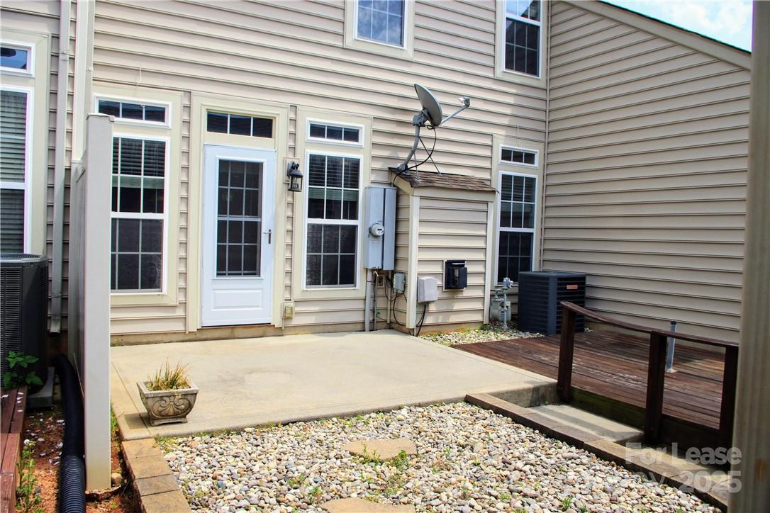 8339 Viewpoint Lane Cornelius, NC 28031 - Photo 28 of 30 a view of a house with a barbeque and bench