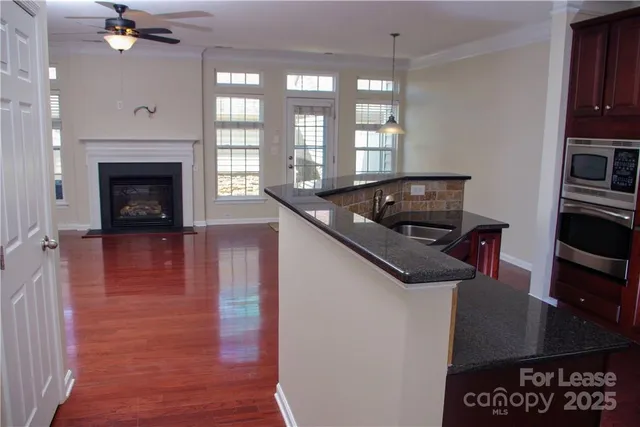 a kitchen with granite countertop a stove and a sink