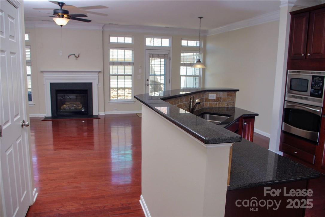 8339 Viewpoint Lane Cornelius, NC 28031 - Photo 8 of 30 a kitchen with granite countertop a stove and a sink
