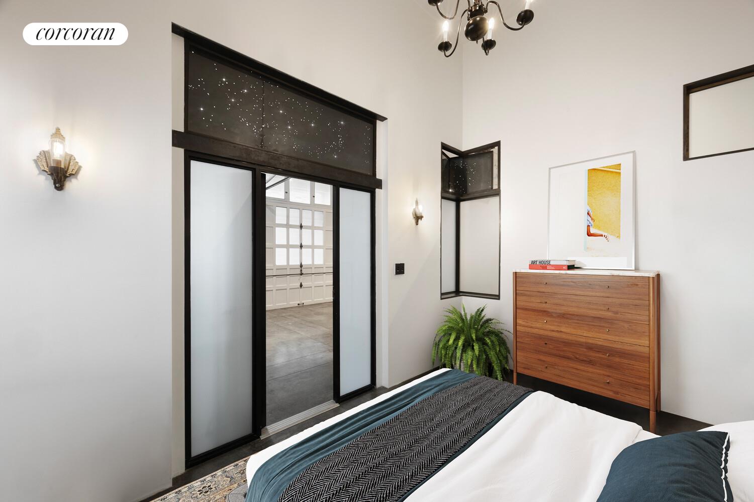 125 Watts Street, Unit 1 Manhattan, NY 10013 - Photo 11 of 18 a bedroom with a bed and a mirror