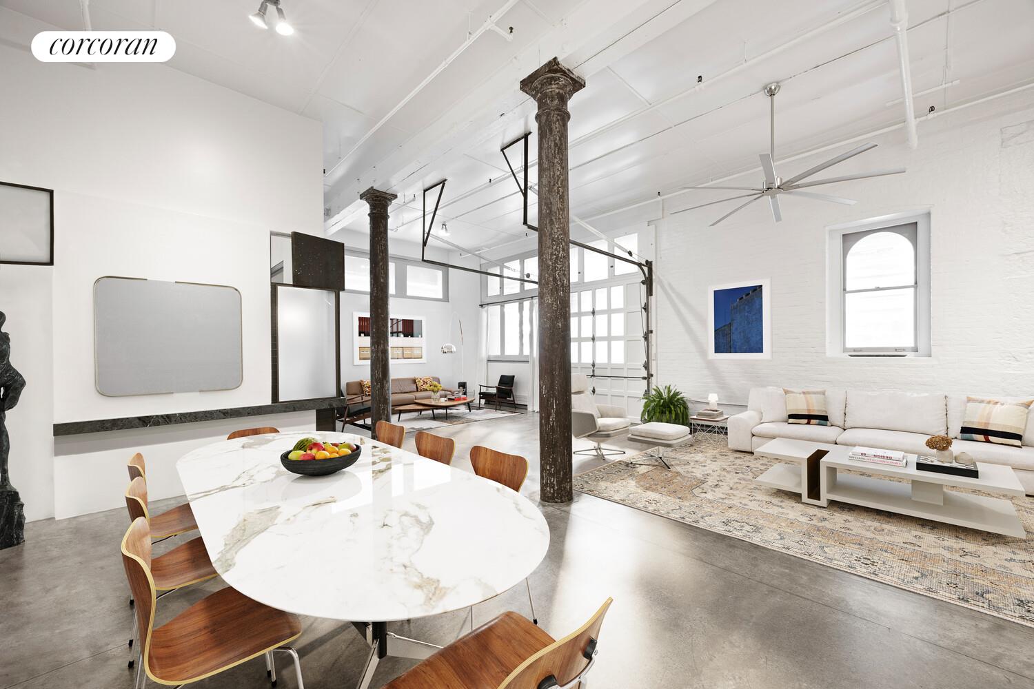 125 Watts Street, Unit 1 Manhattan, NY 10013 - Photo 7 of 18 a kitchen with sink refrigerator dining table and chairs