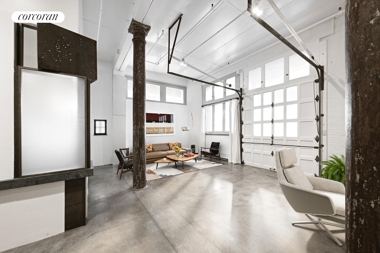 125 Watts Street, Unit 1 Manhattan, NY 10013 - Photo 9 of 18 a living room with furniture and a large window