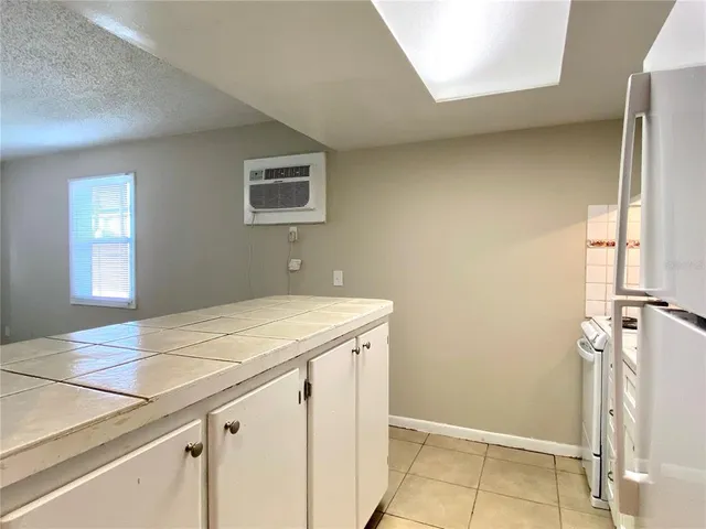 a kitchen with a sink cabinets and wooden floor