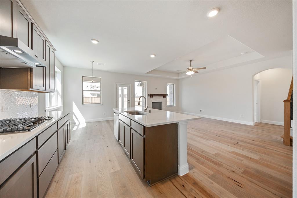 116 Old Glory Lane Forney, TX 75126 - Photo 12 of 23 a kitchen with a stove and a wooden floor