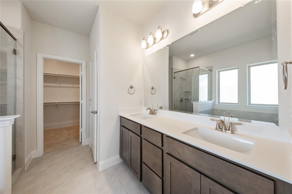 116 Old Glory Lane Forney, TX 75126 - Photo 16 of 23 a bathroom with a sink double vanity and a mirror