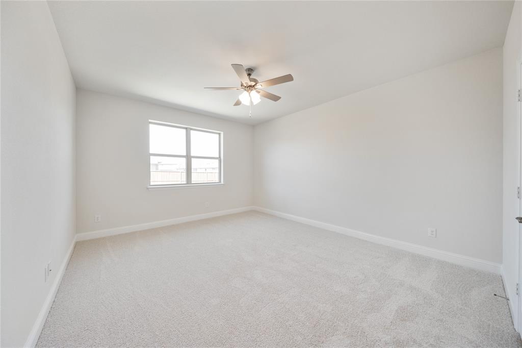 116 Old Glory Lane Forney, TX 75126 - Photo 17 of 23 an empty room with windows and ceiling fan