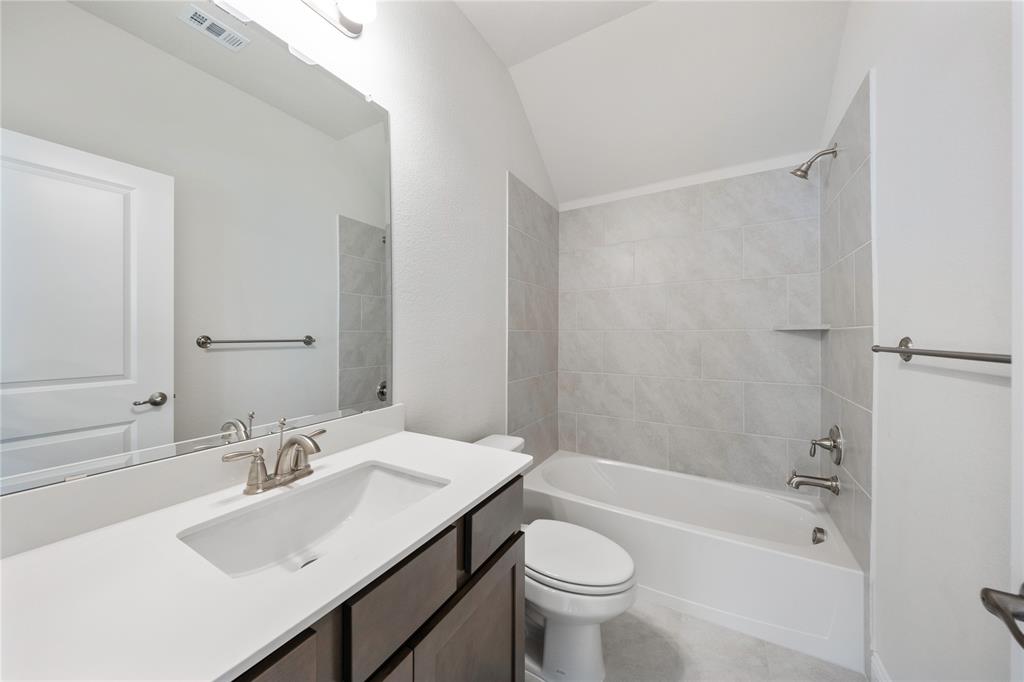 116 Old Glory Lane Forney, TX 75126 - Photo 3 of 23 a bathroom with a sink mirror toilet and bathtub