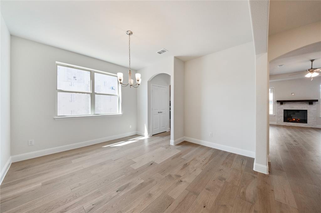 116 Old Glory Lane Forney, TX 75126 - Photo 8 of 23 a view of an empty room with wooden floor fireplace and a window