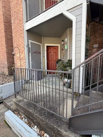 a view of a house with iron fence