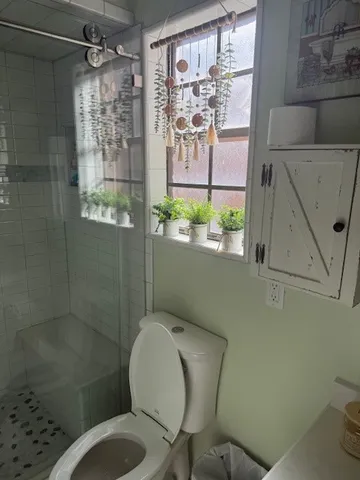 a bedroom with a bed and a ceiling fan