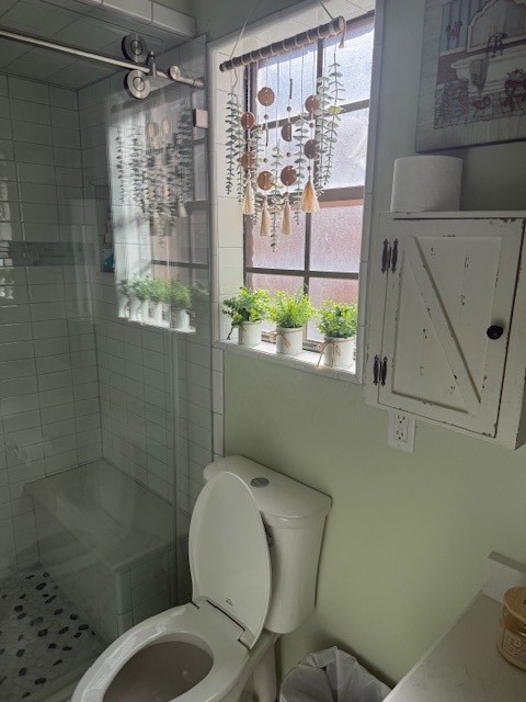 2402 Sycamore Avenue, Unit E3 Huntsville, TX 77340 - Photo 30 of 38 a bathroom with a toilet and shower