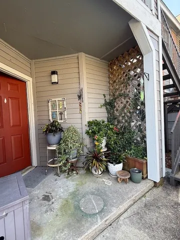 a view of a chair and table in the house