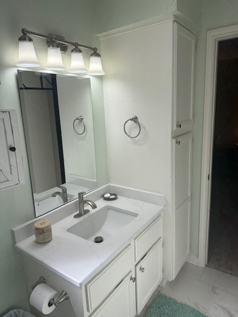 2402 Sycamore Avenue, Unit E3 Huntsville, TX 77340 - Photo 31 of 38 a bathroom with a sink and mirror