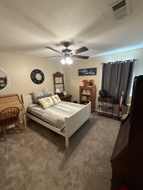 2402 Sycamore Avenue, Unit E3 Huntsville, TX 77340 - Photo 33 of 38 a bedroom with a bed and a ceiling fan