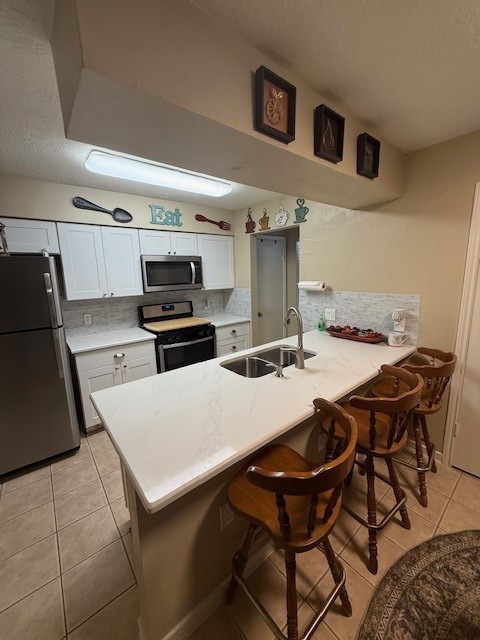 2402 Sycamore Avenue, Unit E3 Huntsville, TX 77340 - Photo 6 of 38 a kitchen with a table chairs and a refrigerator