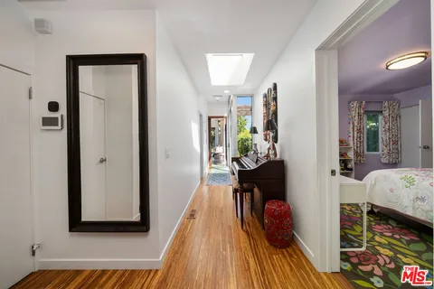 a bedroom with a bed and large windows