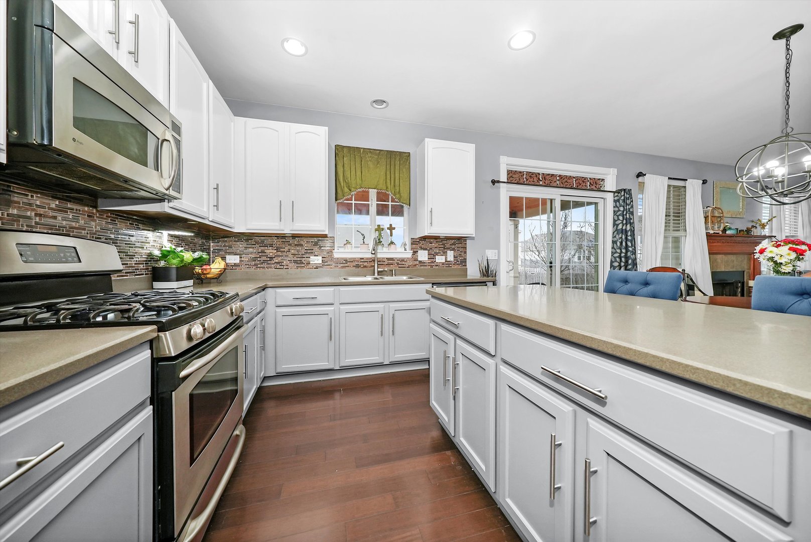 902 Farmstead Lane Shorewood, IL 60404 - Photo 11 of 35 a kitchen with stainless steel appliances granite countertop a sink a stove and a refrigerator