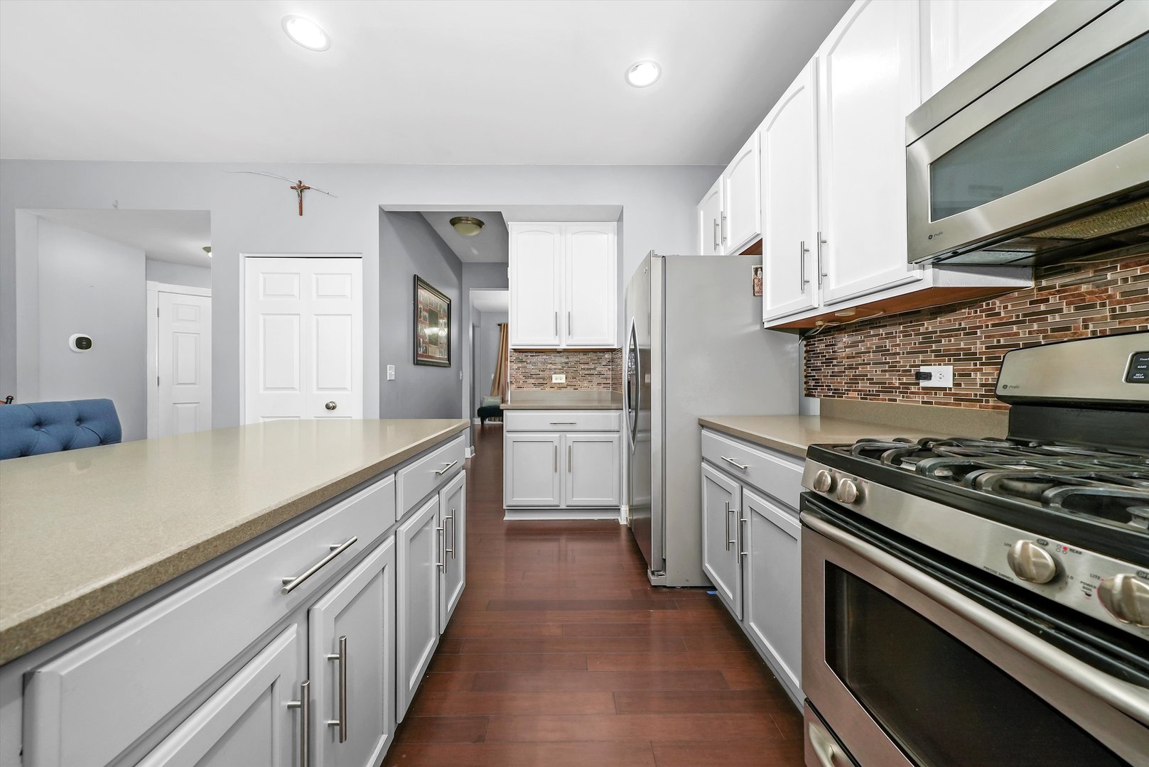 902 Farmstead Lane Shorewood, IL 60404 - Photo 12 of 35 a kitchen with stainless steel appliances a sink cabinets and a stove top oven