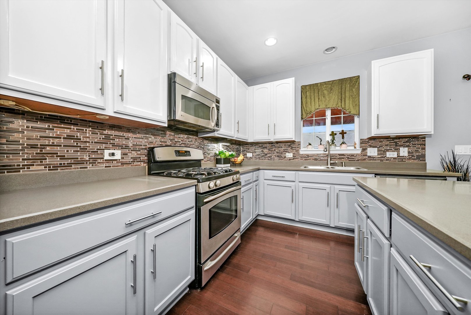 902 Farmstead Lane Shorewood, IL 60404 - Photo 13 of 35 a kitchen with stainless steel appliances granite countertop a sink a stove and cabinets