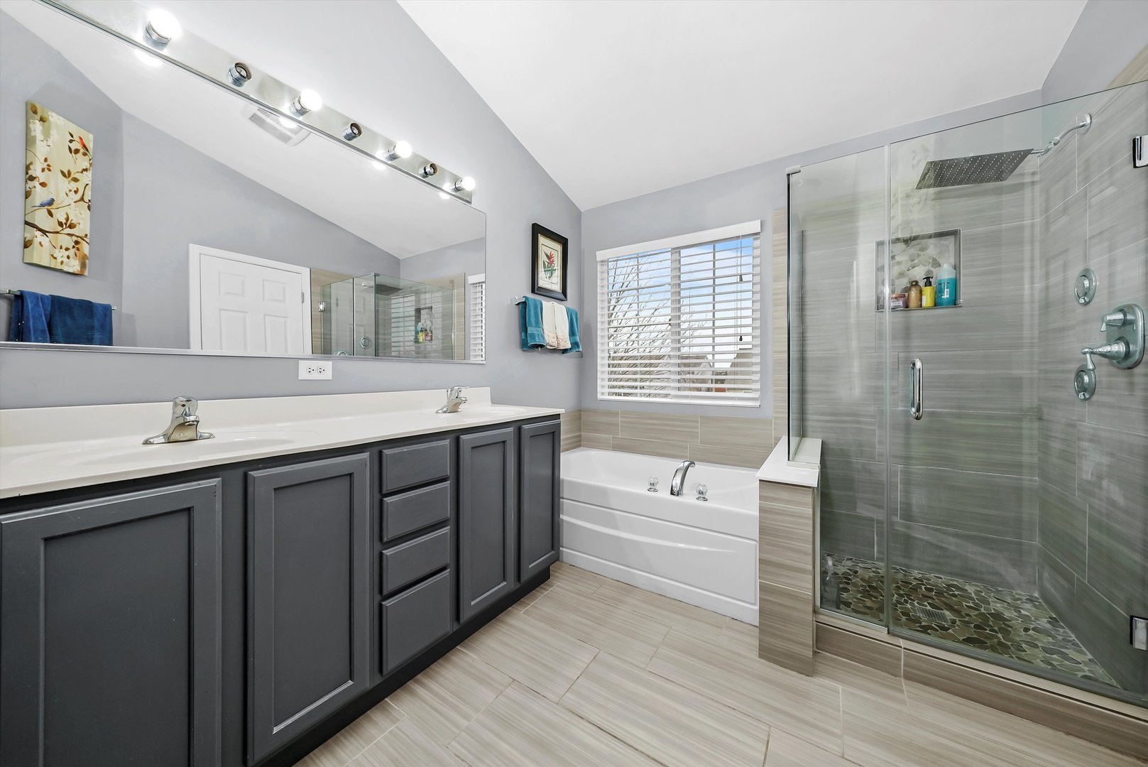 902 Farmstead Lane Shorewood, IL 60404 - Photo 20 of 35 a spacious bathroom with a double vanity sink a large mirror and a bathtub