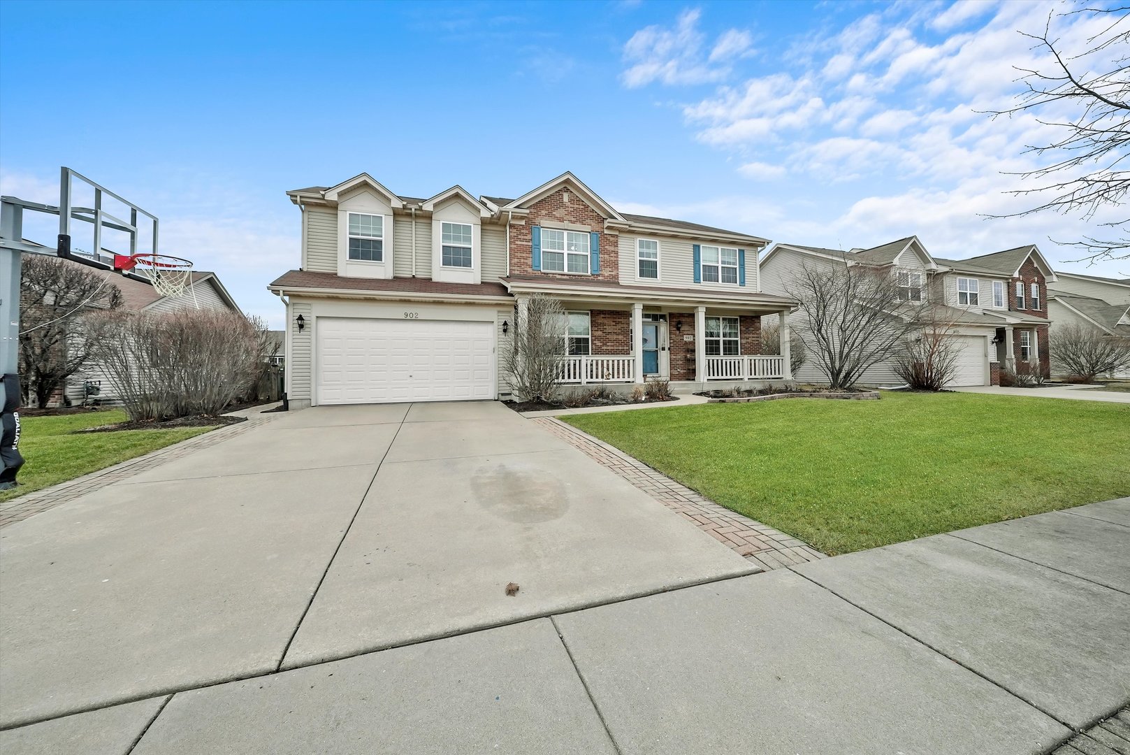 902 Farmstead Lane Shorewood, IL 60404 - Photo 2 of 35 a front view of a house with a garden and yard