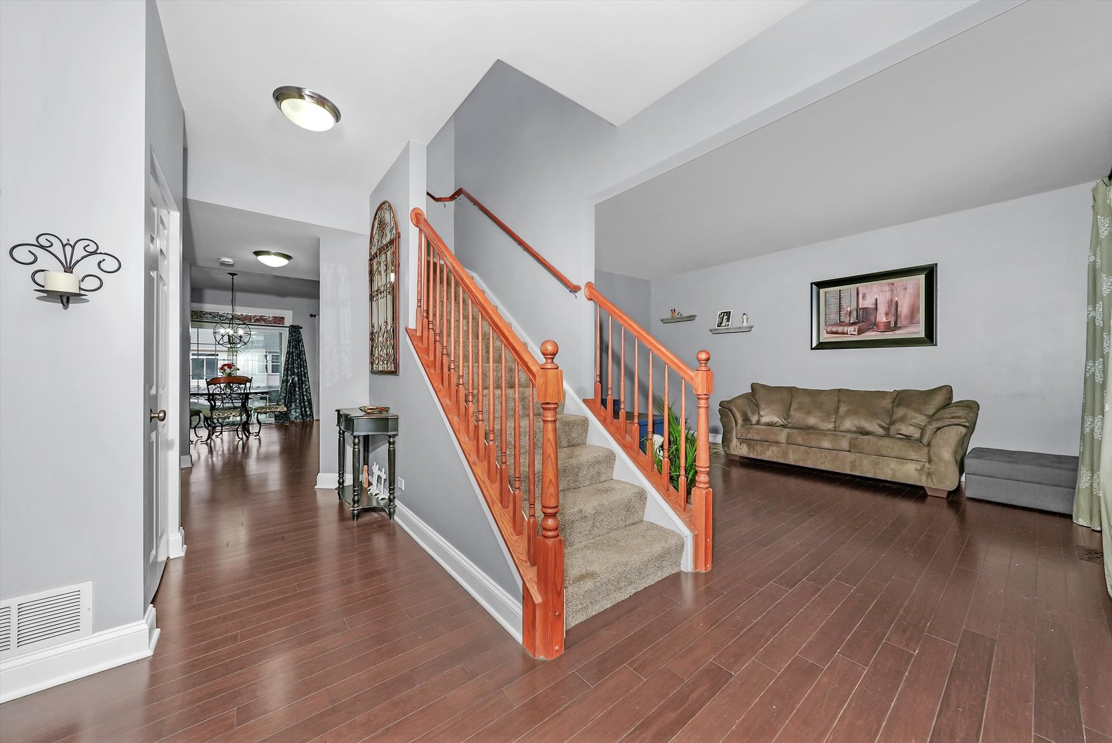 902 Farmstead Lane Shorewood, IL 60404 - Photo 4 of 35 a view of a hallway with wooden floor and stairs