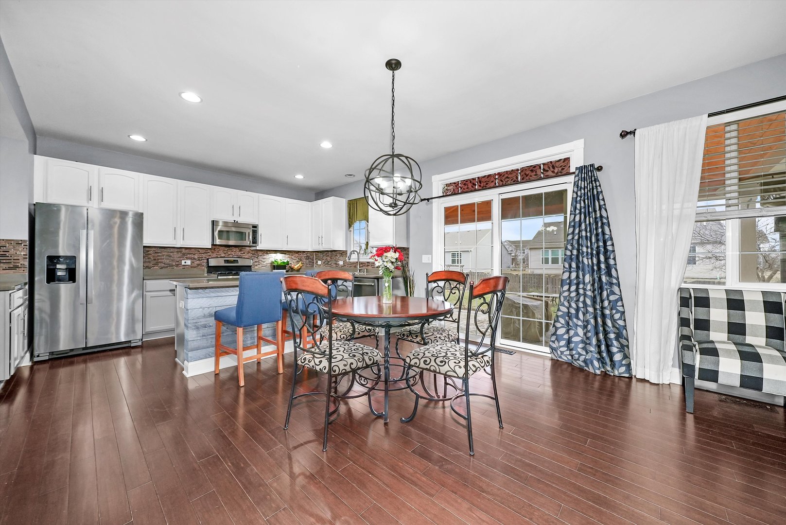 902 Farmstead Lane Shorewood, IL 60404 - Photo 10 of 35 a view of a dining room with furniture window and wooden floor
